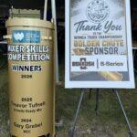 Gold mixer skills competition trophy with winners list beside a sign thanking the Golden Chute sponsor for the WRMCA Truck Championship.